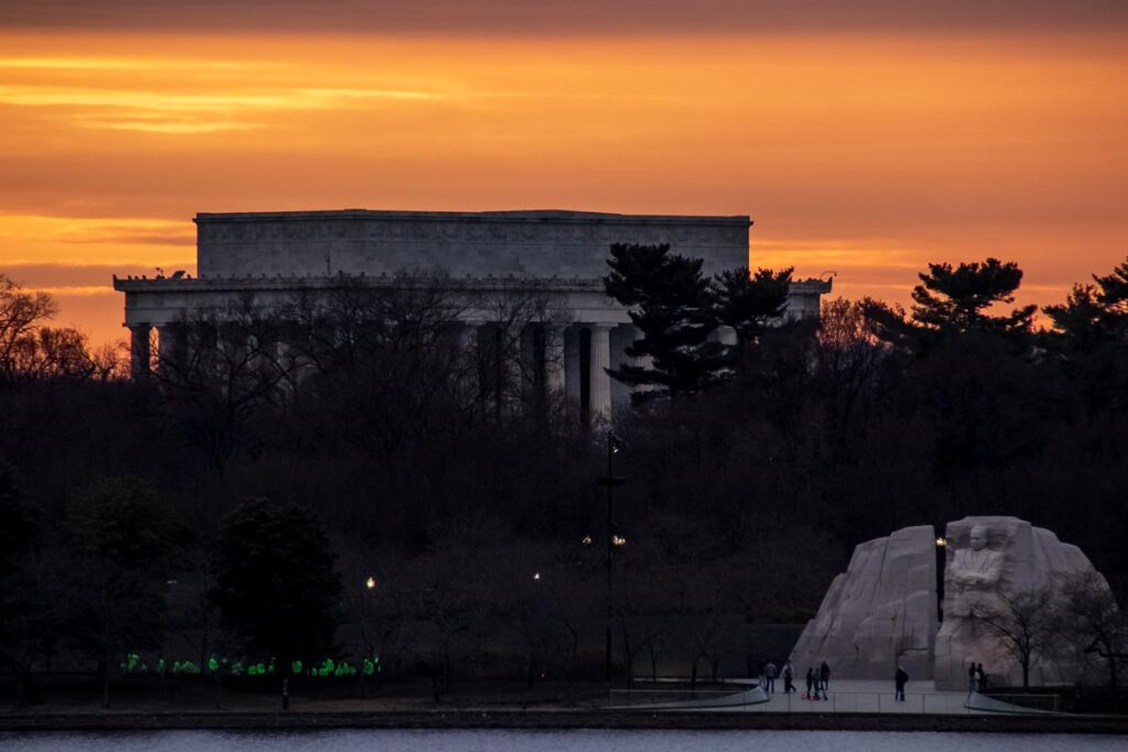 Sunset behind the Lincoln and MLK Memorials in Washington DC, where tourists gather to remember.